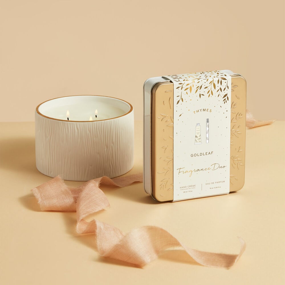 Thymes Goldleaf Fragrance Duo in Package Beside White Candle image number 1